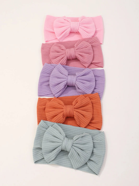 Prenda multicolor diadema para bebe con moño acanalado vista frontal