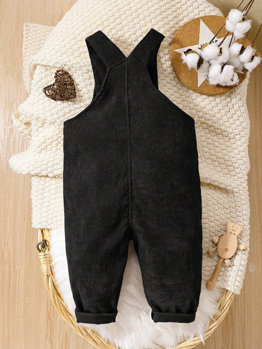 Prenda negro overol para bebe vista trasera con tirantes cruzados