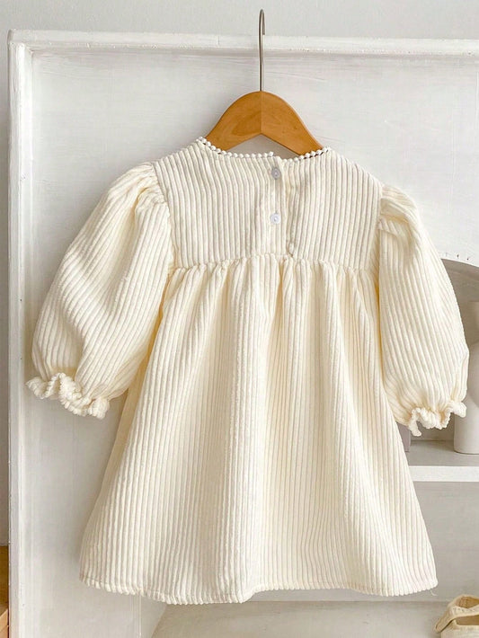 Prenda crema vestido para bebe con mangas largas vista posterior