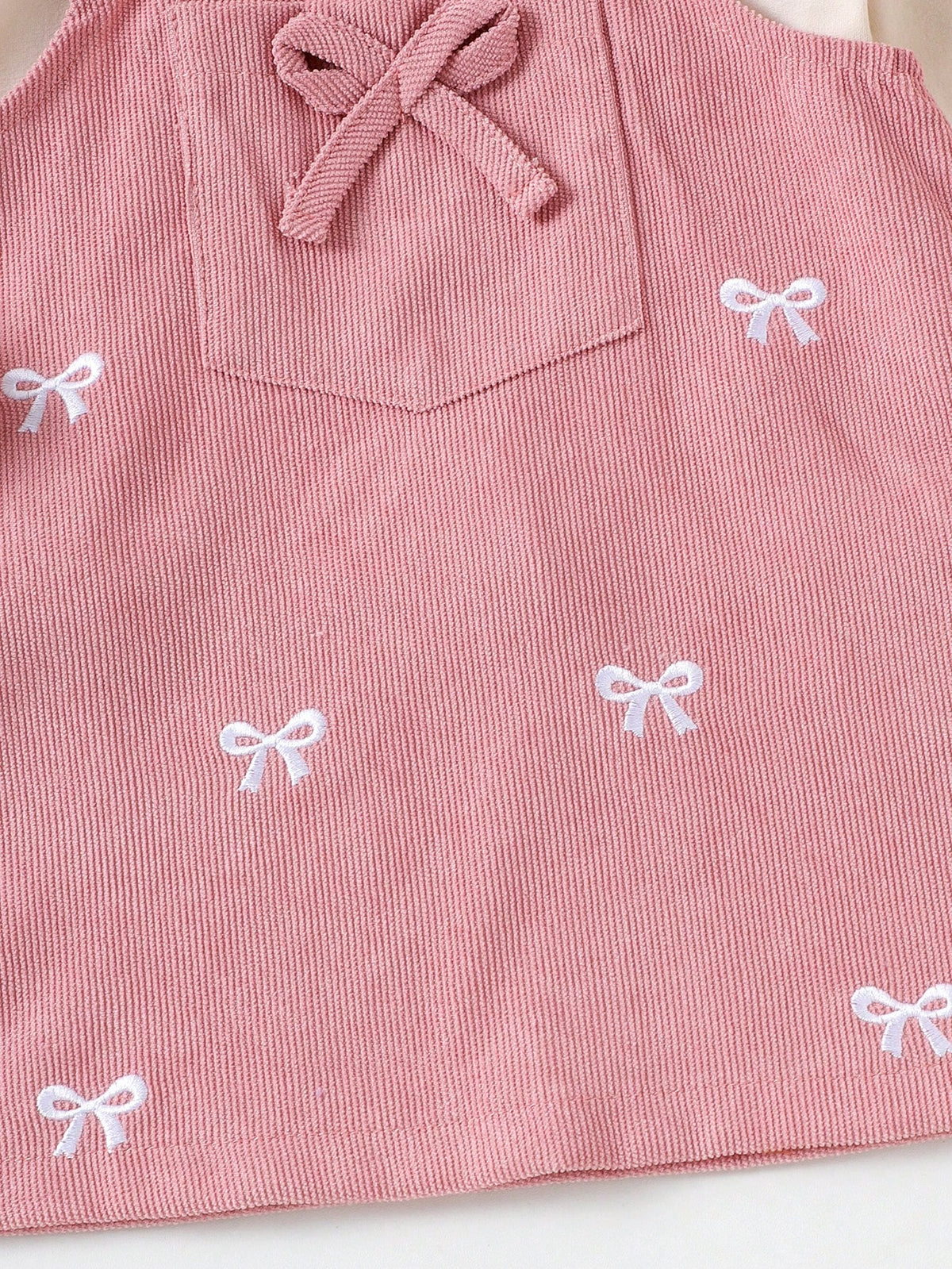Prenda rosa vestido para bebe detalle de lazos bordados y bolsillo