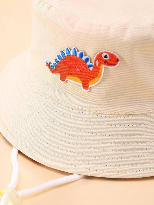 Prenda beige sombrero cubo para bebe con detalle de dinosaurio bordado