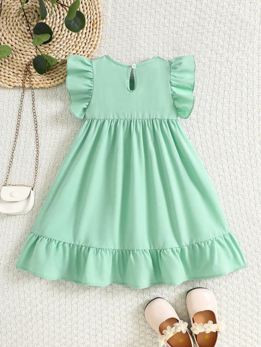 Prenda verde menta vestido para bebe con lazo y volantes vista posterior