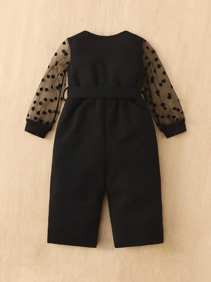 Prenda negra enterizo para bebe con malla de lunares vista trasera