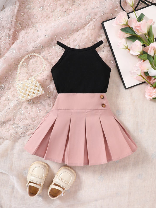 Prenda negro y rosa conjunto para bebe con falda plisada vista frontal
