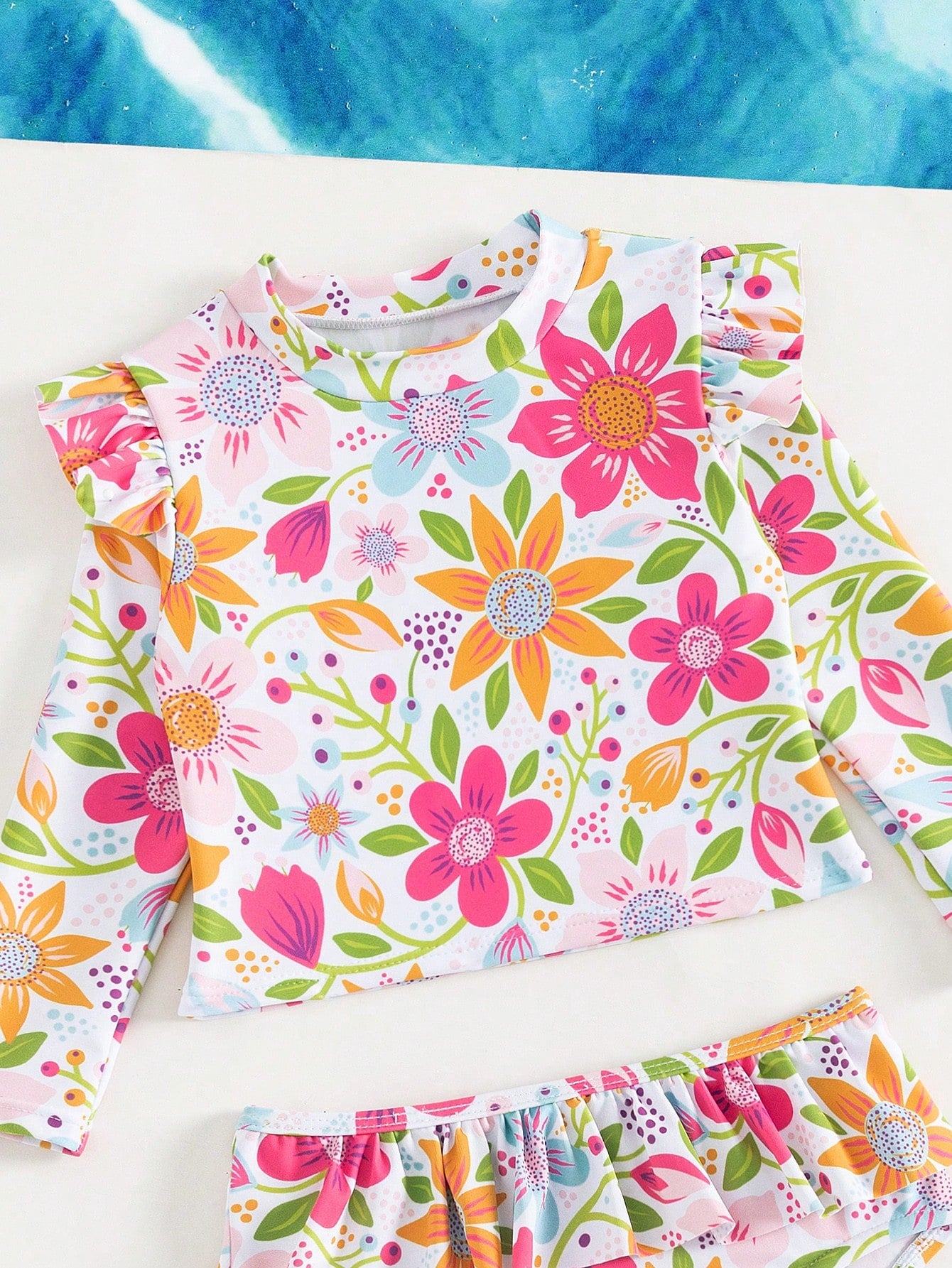 Prenda multicolor traje de baño floral para bebe detalle superior