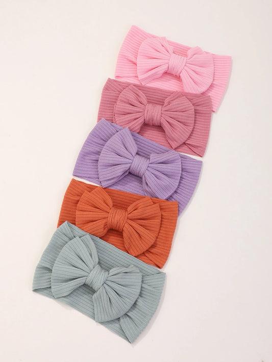 Prenda multicolor diadema para bebe con moño acanalado en tonos pastel
