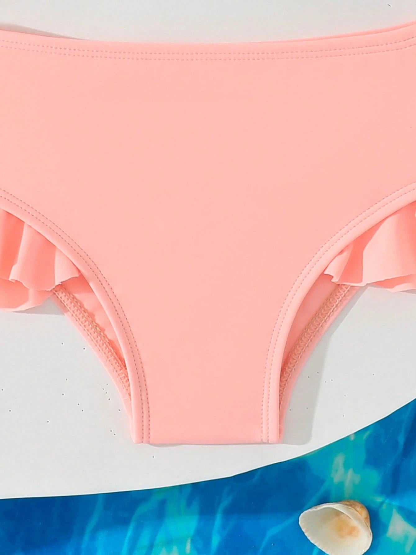 Prenda albaricoque traje de baño floral para bebe detalle inferior