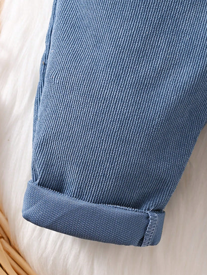 Prenda azul overol para bebe detalle de la tela de pana y bajos doblados