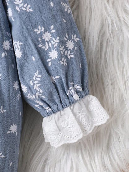Prenda azul vestido para bebe con detalle de puño con volante y bordado