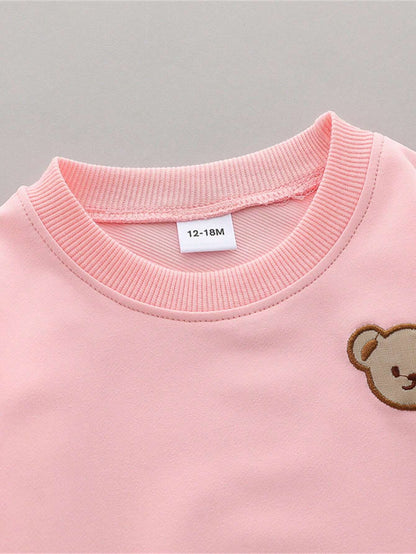 Prenda rosa sudadera para bebe con detalle de cuello y parche de oso