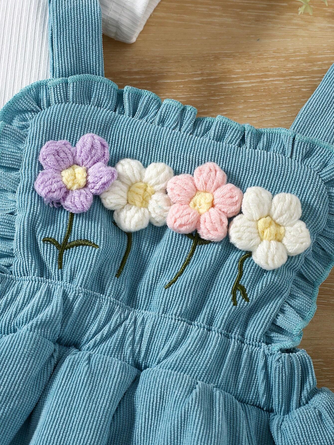 Prenda azul conjunto para bebe con bordado floral detalle