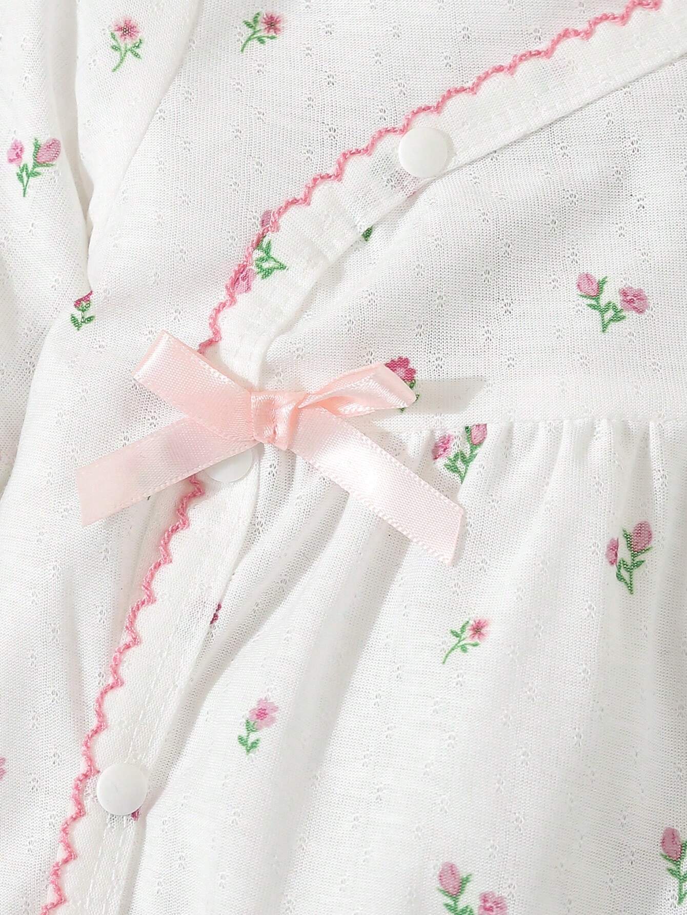 Prenda blanca pijama enterizo para bebe con lazo rosa detalle frontal
