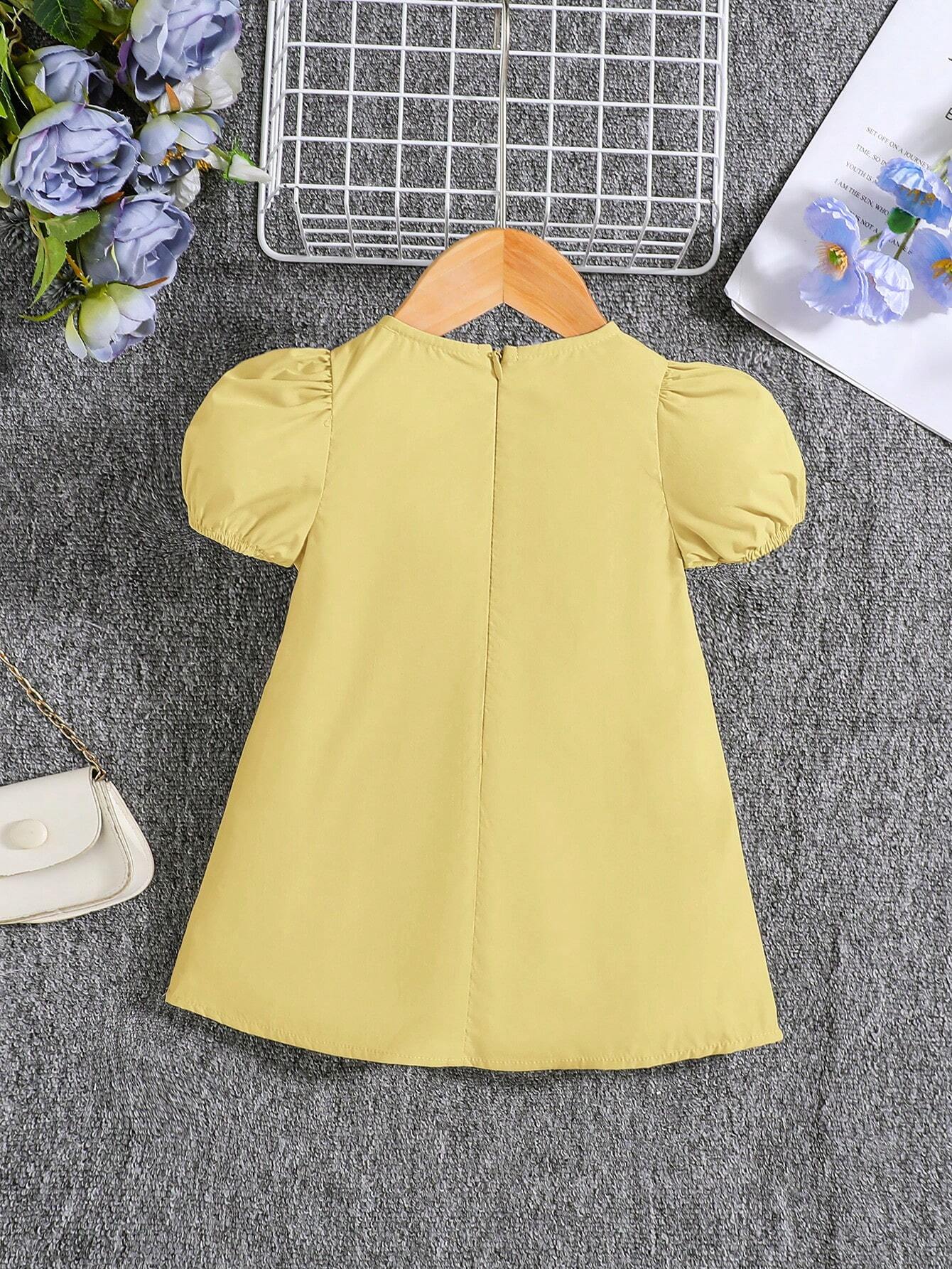 Vestido amarillo con lazos y manga farol