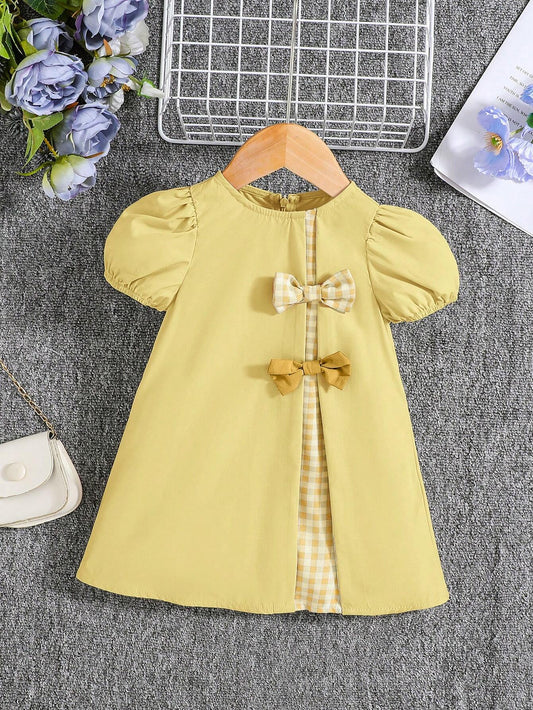 Vestido amarillo con lazos y manga farol