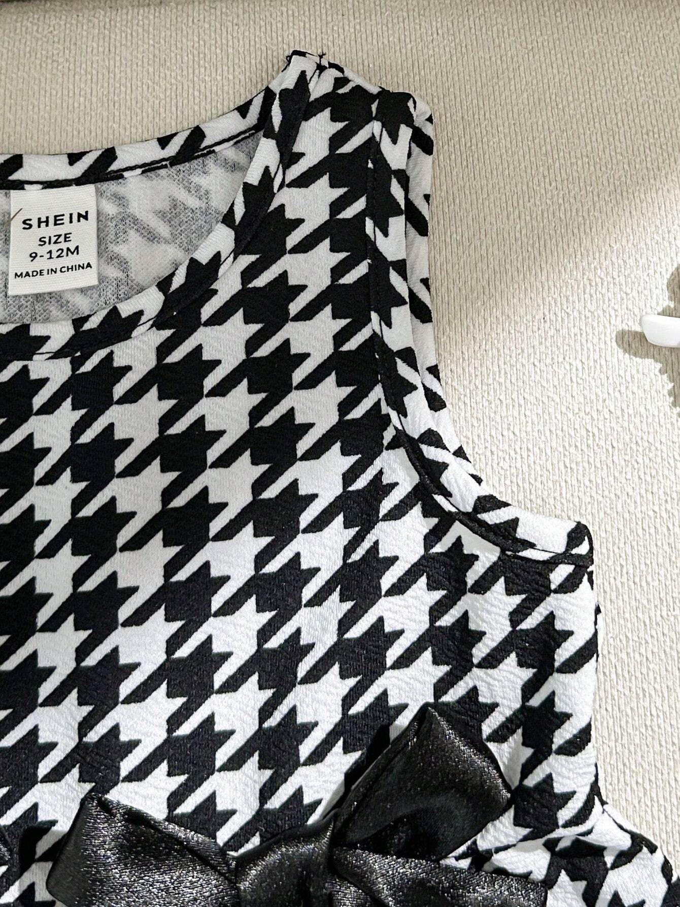 Prenda negro vestido para bebe detalle de tela y costuras
