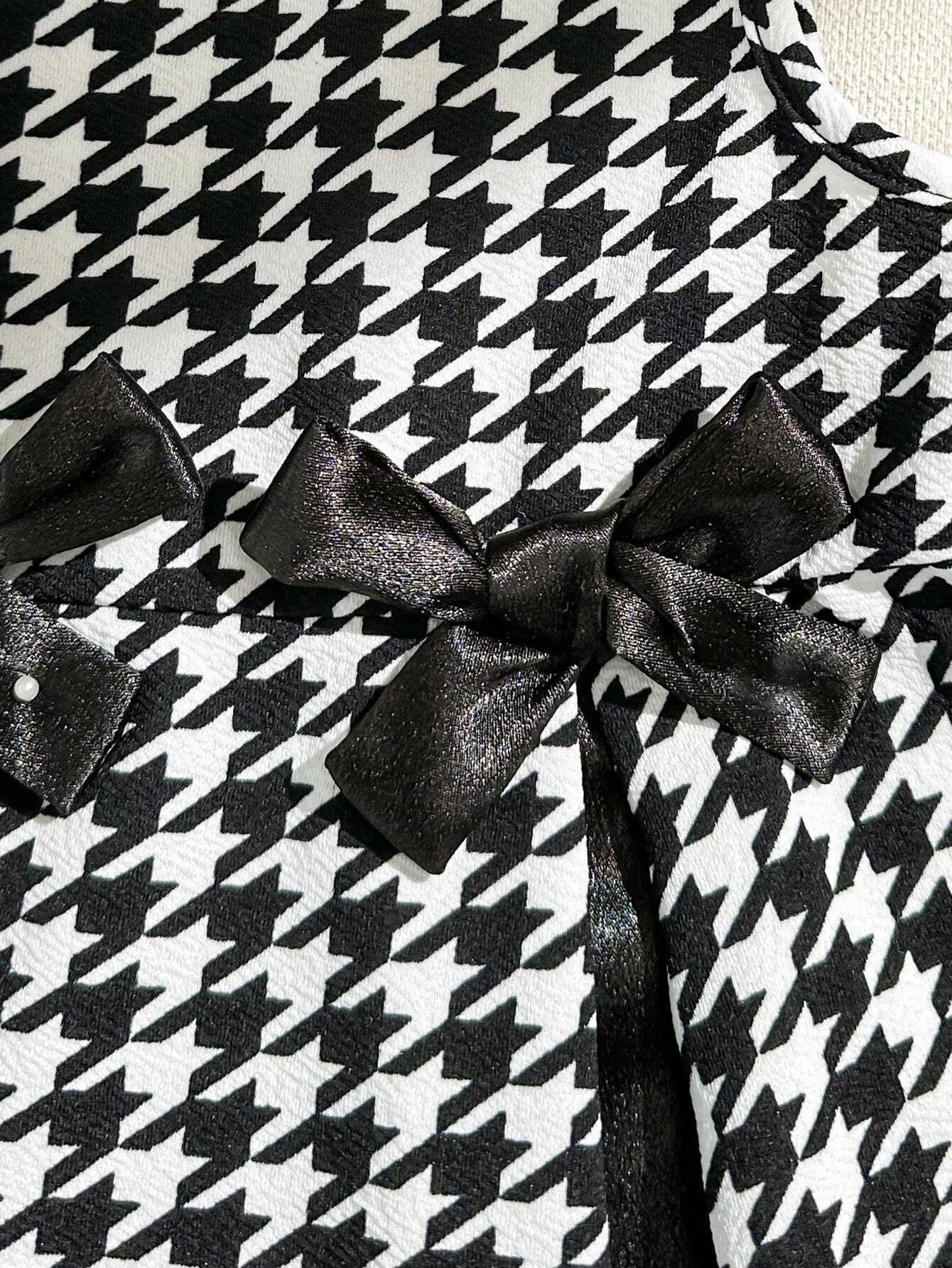 Prenda negro vestido para bebe detalle de lazo decorativo