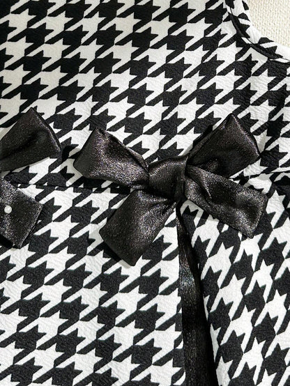 Prenda negro vestido para bebe detalle de lazo decorativo