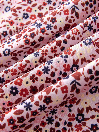 Prenda rosa viejo vestido para bebe vista frontal con falda floral y lazo