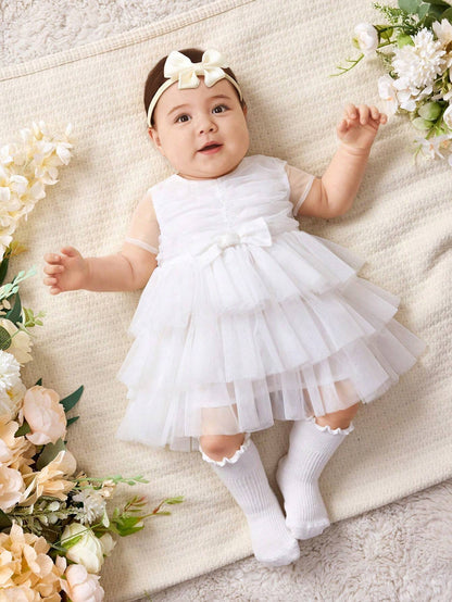 Vestido blanco elegante de malla con lazo