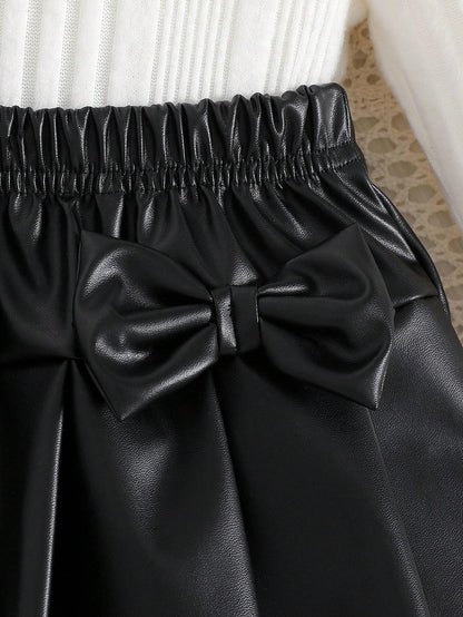 Prenda negro falda plisada para bebe con lazos decorativos