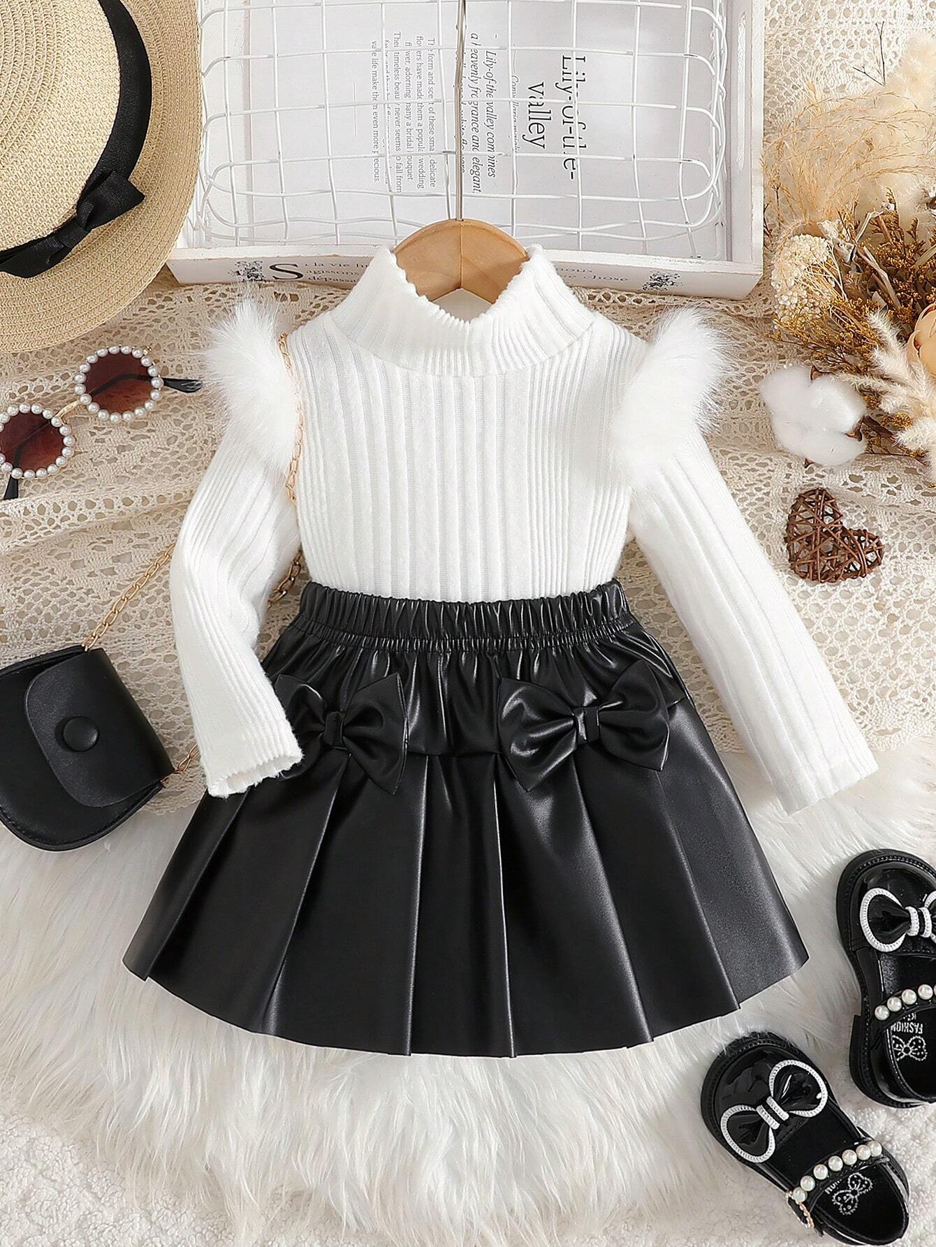 Prenda blanca conjunto para bebe con falda negro plisada vista frontal