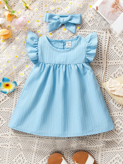 Vestido azul liso con diadema de moña