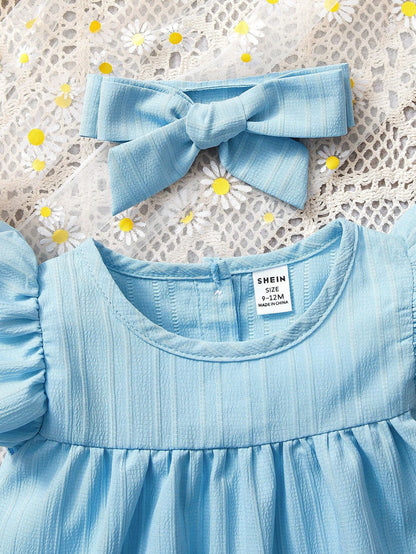 Vestido azul liso con diadema de moña
