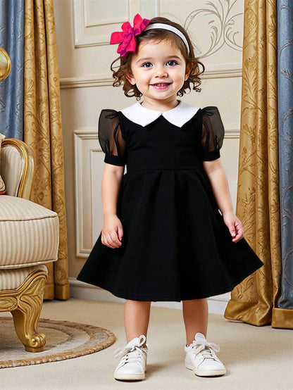Vestido negro elegante con mangas farol y cuello blanco