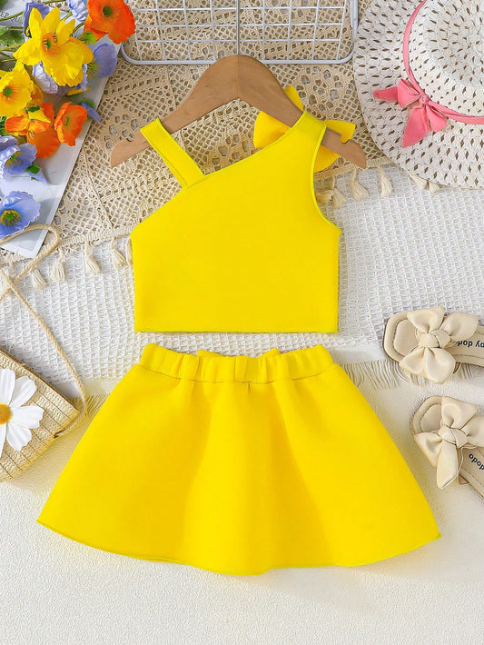 Set amarillo bebé niña con top de tirantes y falda con moño