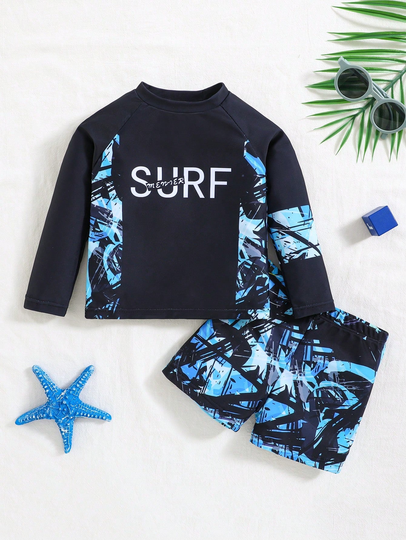 Prenda azul traje de baño para bebe camiseta surf manga larga y shorts vista frontal