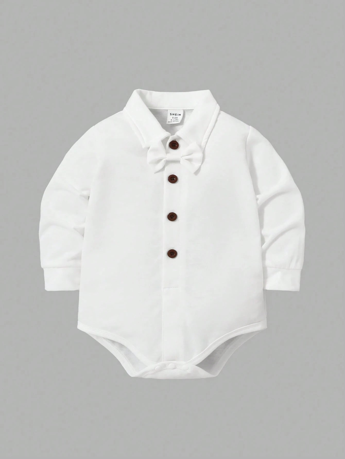 Prenda blanca body para bebe con botones frontales y corbatín

