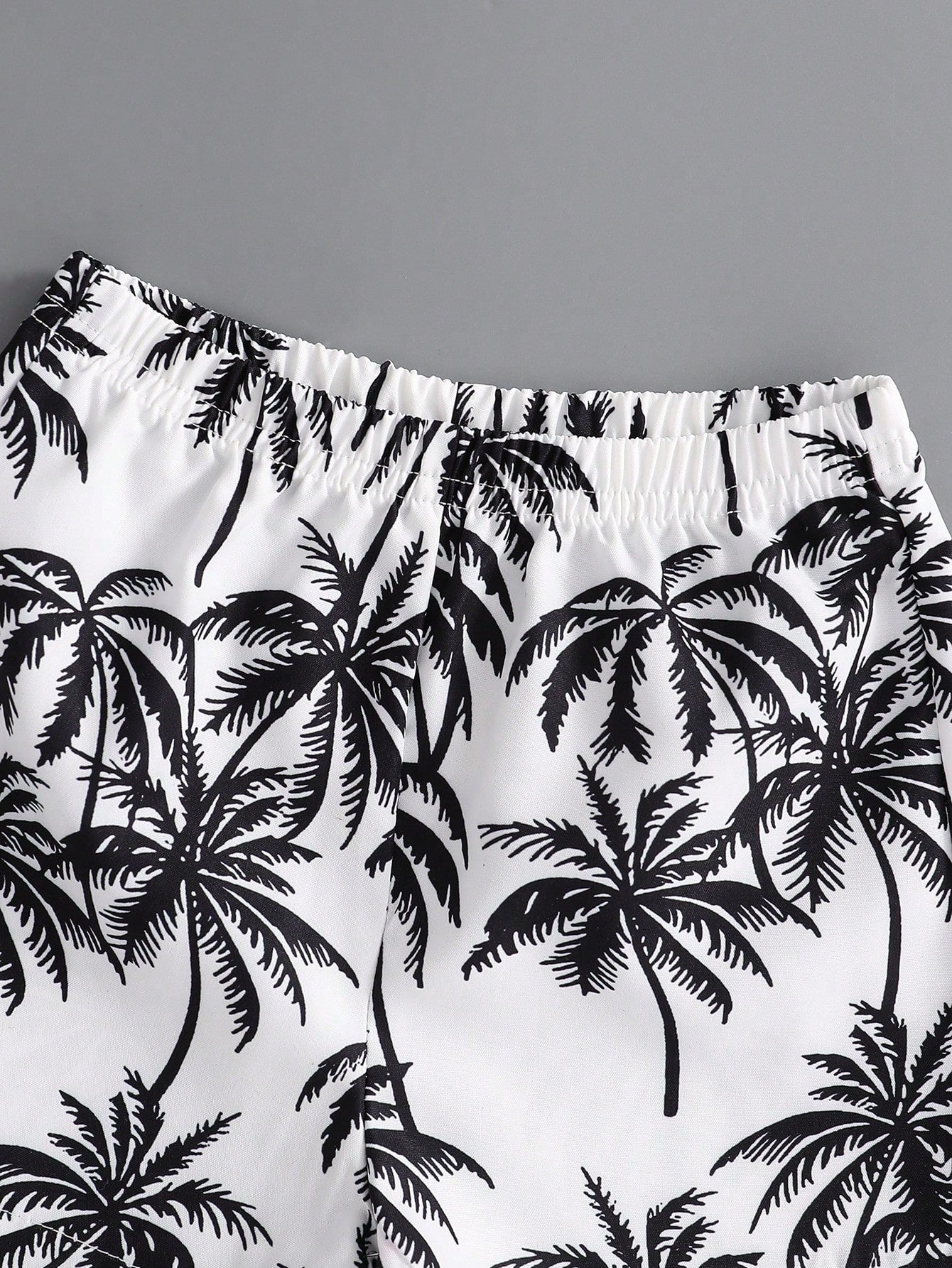 Prenda blanco negro short para bebe con estampado tropical cintura elastica