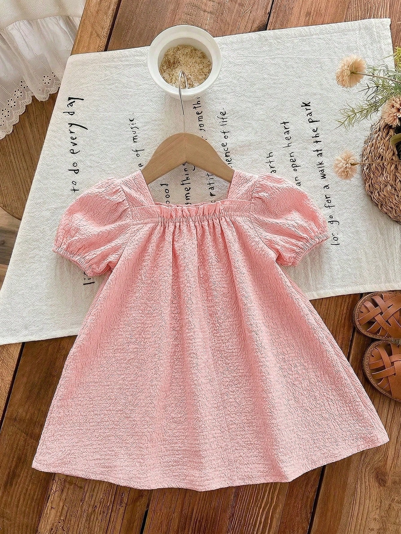 Prenda rosa pálido vestido para bebe con manga abullonada vista posterior
