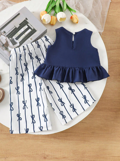 Prenda azul marino conjunto para bebe con top elegante y pantalón estampado vista trasera