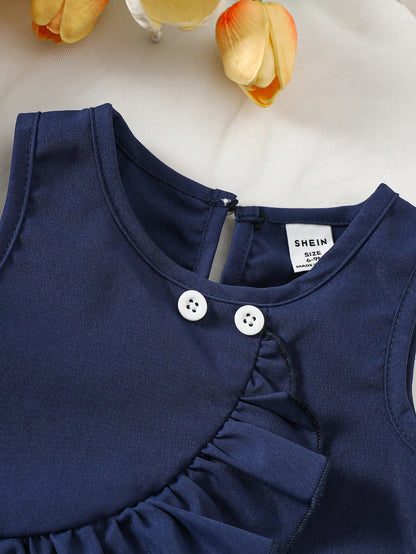 Prenda azul marino top para bebe con botones decorativos detalle del acabado