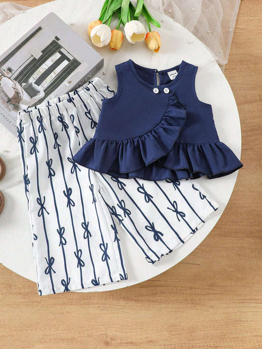 Prenda azul marino conjunto para bebe con top de volantes y pantalón estampado vista frontal