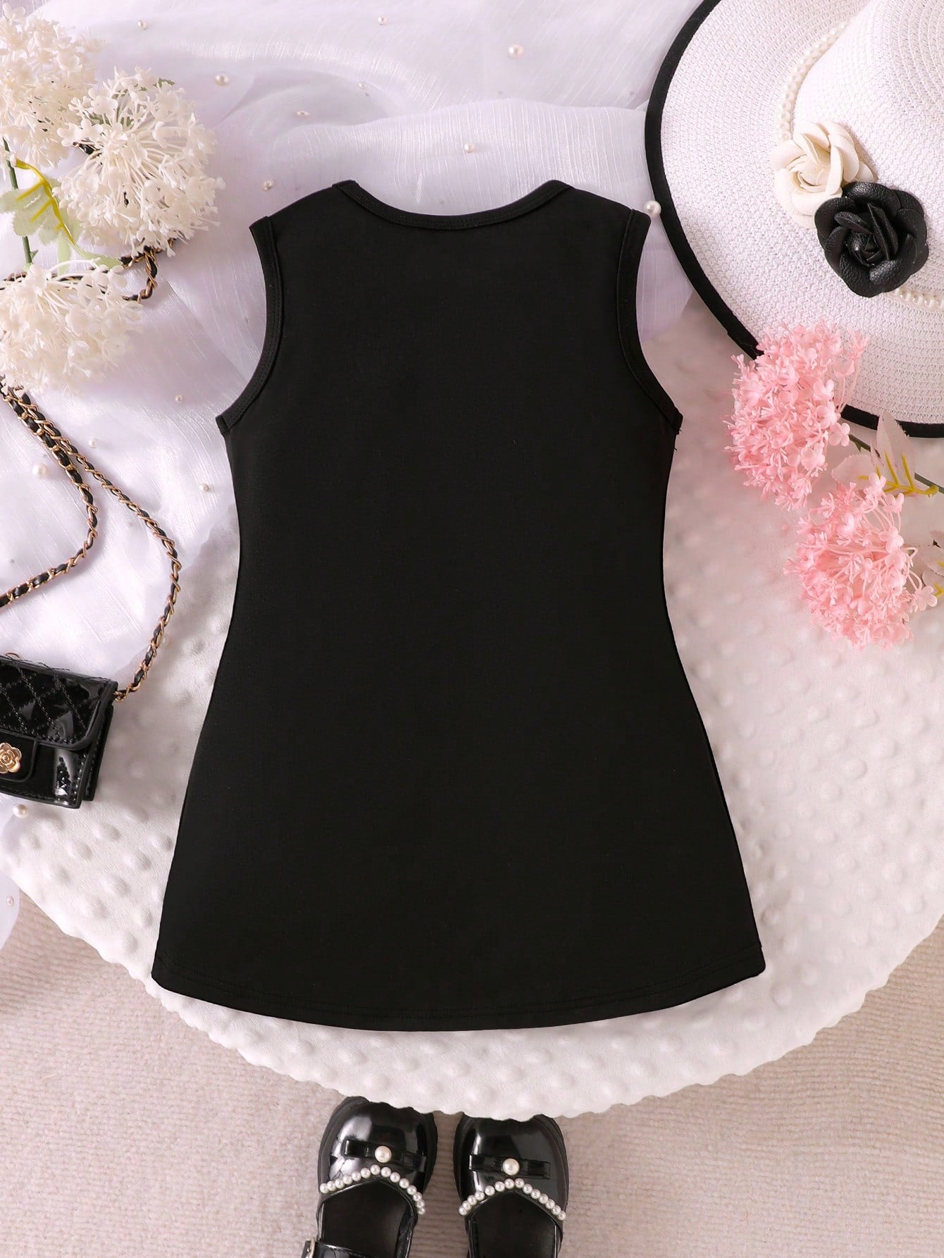 Prenda negro vestido para bebe vista trasera diseño liso
