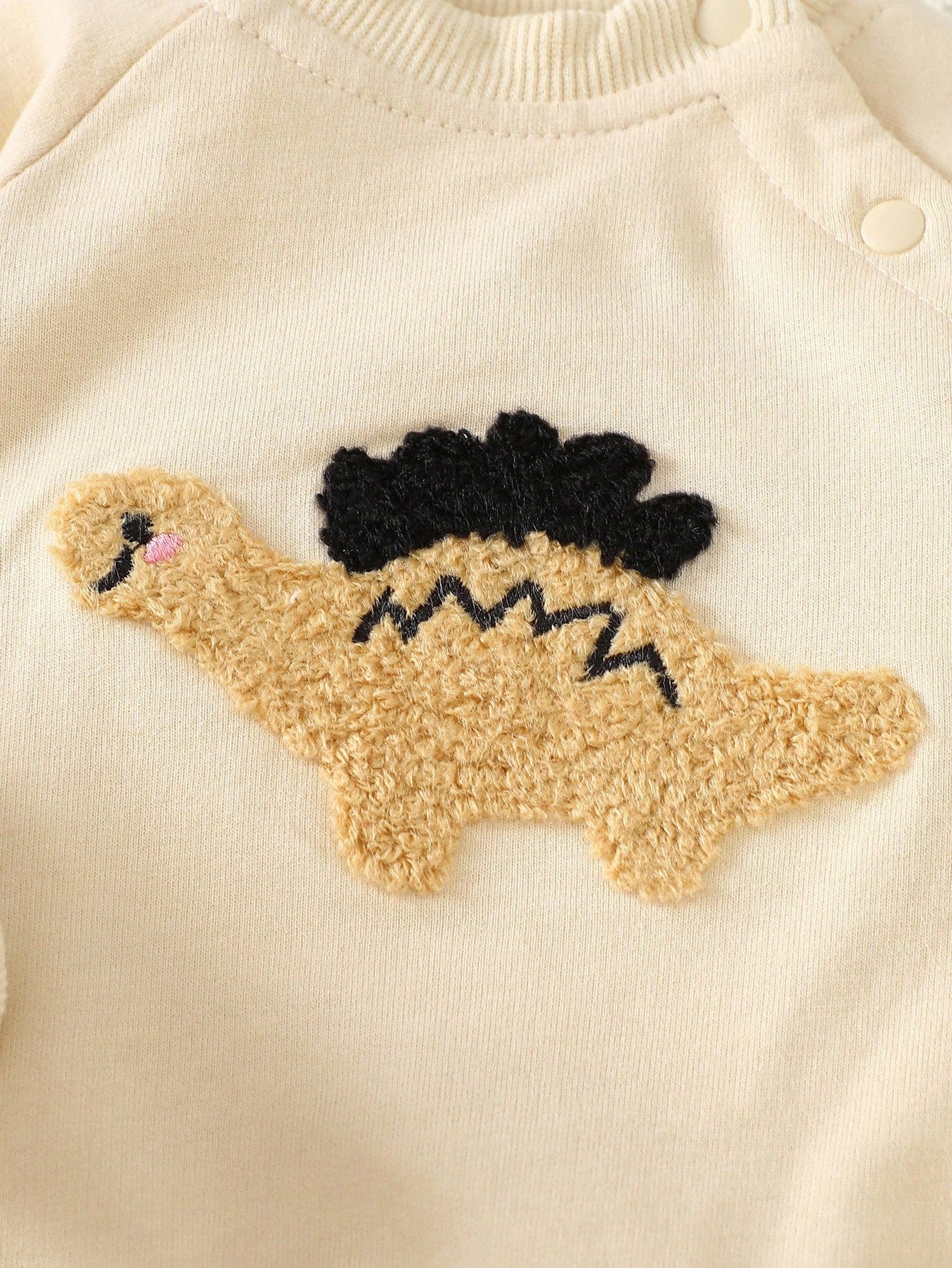 Conjunto albaricoque con sudadera dinosaurio y pantalón a rayas