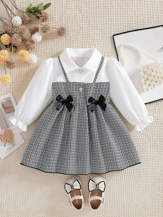 Prenda blanco negro vestido para bebe con lazos elegantes vista frontal

