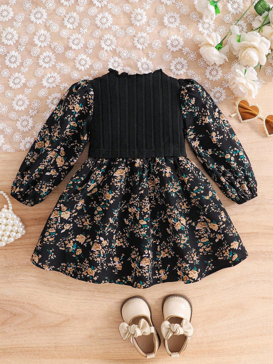 Prenda negro vestido para bebe con estampado floral vista trasera
