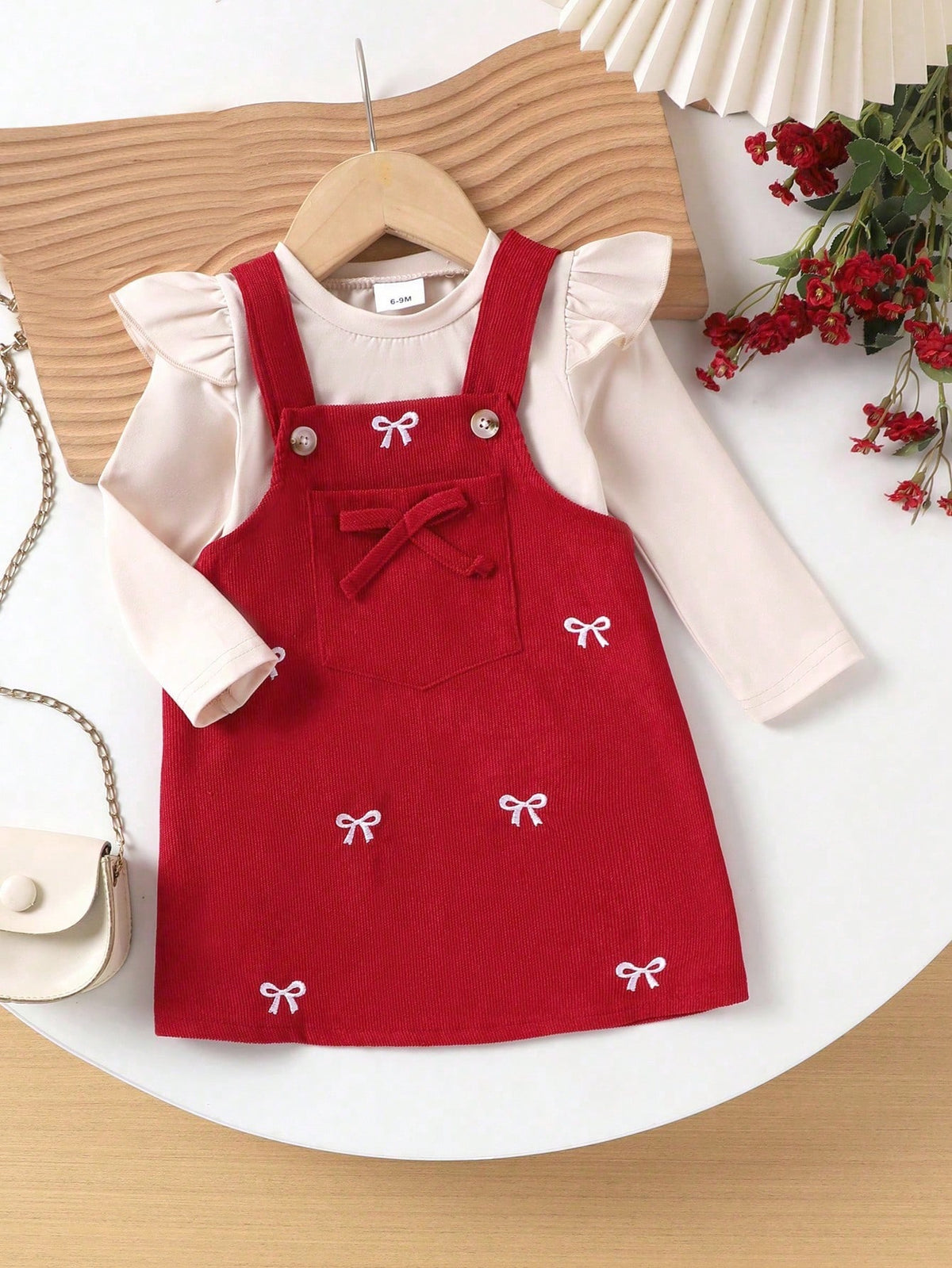 Prenda burdeos conjunto para bebe con vestido de tirantes y lazos bordados vista frontal