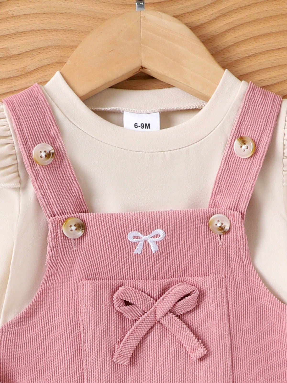 Prenda rosa vestido para bebe detalle de botones y lazo frontal