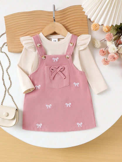 Prenda rosa conjunto para bebe con vestido de tirantes y lazos bordados vista frontal