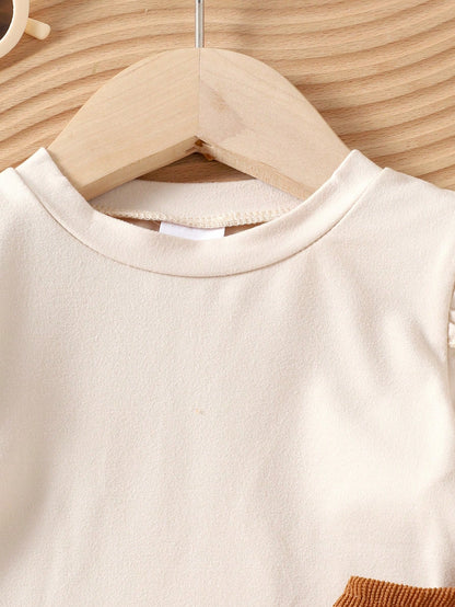 Prenda beige blusa para bebe detalle de cuello redondo y manga larga