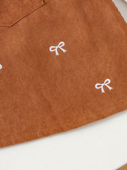 Prenda albaricoque vestido para bebe detalle de lazos bordados
