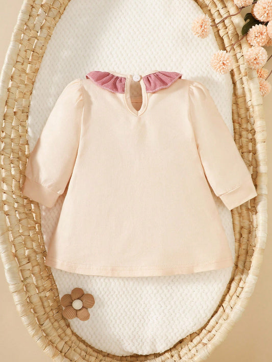 Prenda albaricoque vestido para bebe vista trasera con cuello volante
