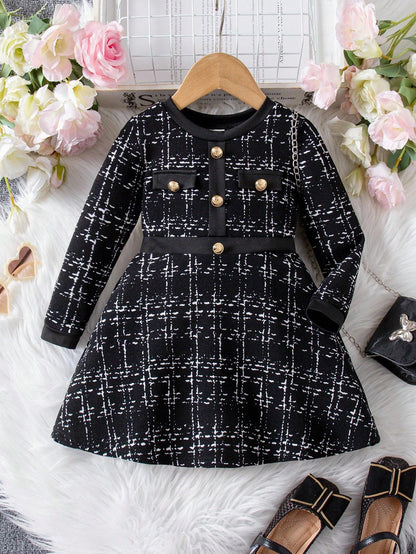Prenda negro vestido para bebe con cuadros y botones dorados vista frontal
