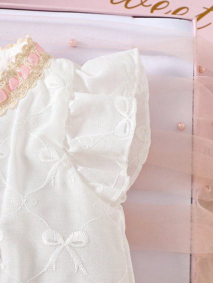 Prenda blanca vestido para bebe con detalle de mangas con volantes y bordado de lazos