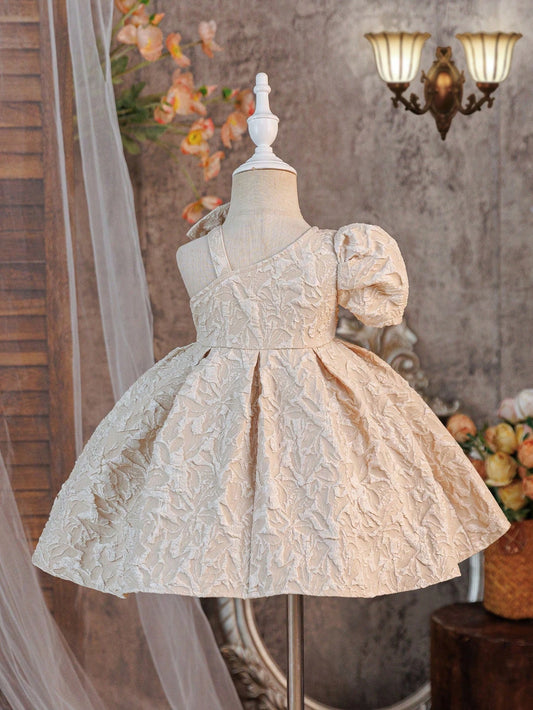 Prenda champán vestido para bebe con lazo asimétrico vista trasera