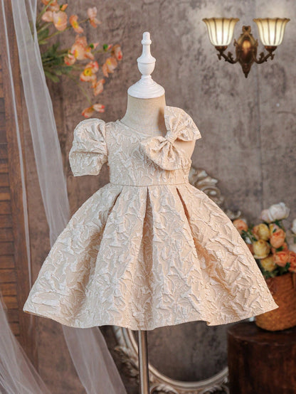 Prenda champán vestido para bebe con lazo asimétrico vista frontal